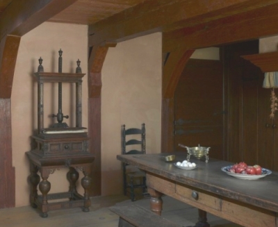 Carved napkine press with drawer near dining table